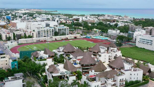 football field at sports complex on coastline of Playa del Carmen town in Mexico, aerial