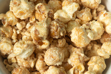 popcorn with butter caramel flavor on a white bowl and white background