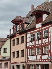 Old historic architecture in Nuremberg, Germany. Traditional European old town buildings with wooden windows, shutters and colourful pastel walls. Aesthetic summer vacation, tourism background