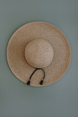 Fototapeta na wymiar Fashion background with straw hat on blue. Flatlay, top view