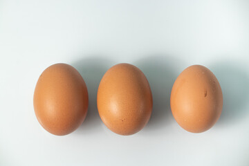 Chicken egg on white background and bowl