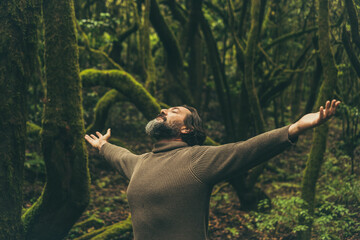 Nature care environment lifestyle people concept. One man opening arms and hugging the forest with...