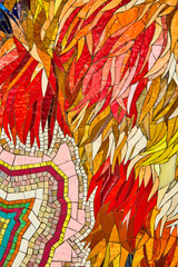 Detail of mosaic art colorful fire red and orange pieces in subway of New York City
