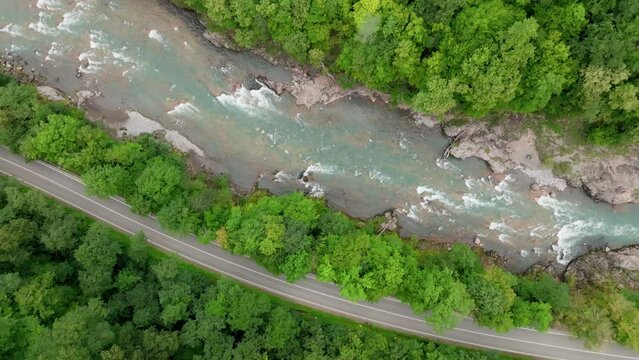 Aerial view of Mountain river and road. Flying over a mountain gorge