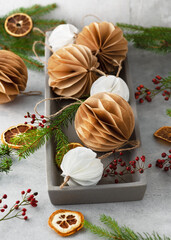 Christmas Honeycomb ball made from white und brown coffee filter. Handmade Christmas tree decoration. Seasonal activity with kids. 