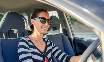 Beautiful young woman driving a car.