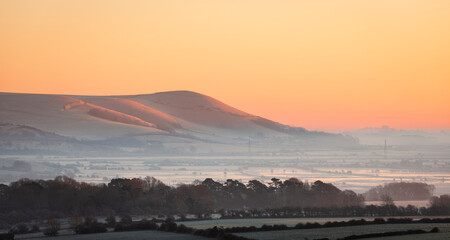 Mount Caburn rising from mist in the Ouse valley from Kingston Ridge south downs east Sussex south east England © SuxxesPhoto