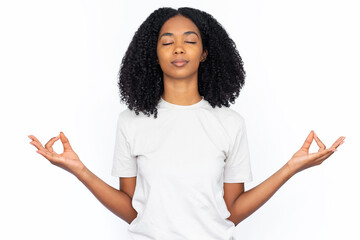 Relaxed multiracial woman with mudra gesture. Portrait of calm young female model with dark curly...