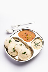 Idly sambar or Idli with Sambhar and green, red chutney. Popular South indian breakfast