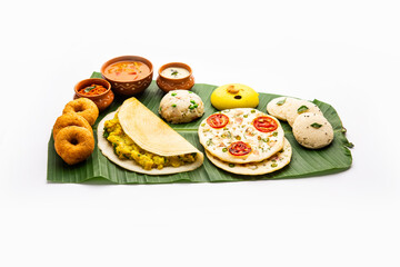 South Indian Masala Dosa, Uttapam, Idli vada sambar, semolina halwa, upma served over banana leaf