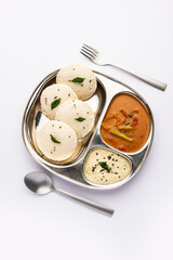 Idly sambar or Idli with Sambhar and green, red chutney. Popular South indian breakfast