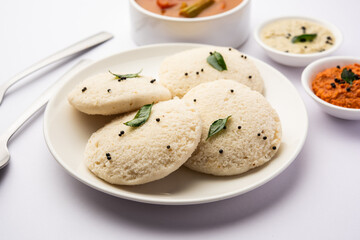 Idly sambar or Idli with Sambhar and green, red chutney. Popular South indian breakfast