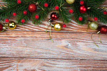 Christmas and New Year composition with a Christmas tree and Christmas decorations on a wooden background. Top view. Place for text. Selective focus.