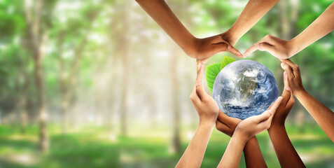 Conceptual symbol of multiracial human hands surrounding the Earth globe. Unity, world peace, humanity concept. World environment day- Earth Day concept. Elements of this image furnished by NASA.