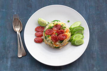 Chinese sausage fried rice on blue wood table.