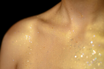 Fototapeta premium Closeup human skin with golden makeup. Selected focus with depth of field.