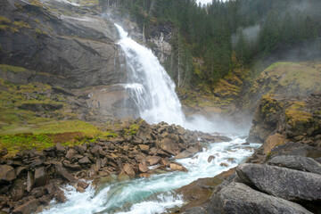 Krimml Waterfalls, Krimmler Wasserfalle,in High Tauern National Park, Austria. Krimmler Ache river falls. Beautiful dramatic waterfall on a misty rainy day. Hiking in Austrian Alps.