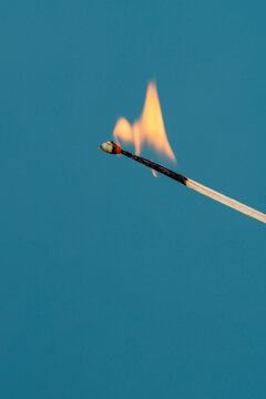 burning match on a dark background
