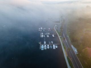 A Foggy morning at Fremantle road and rail bridges, Misty swan river from above. 