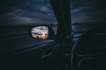 driving on the highway at the sunset, moody