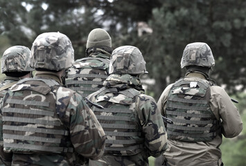 Soldiers with assault rifles from the back.