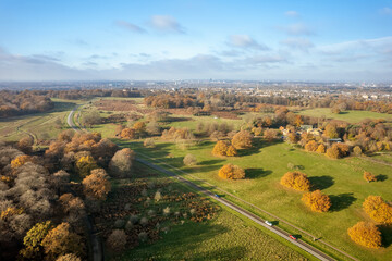 Aerial view of Richmond Park in autumn with city of London in the background.  Richmond Park, in the London Borough of Richmond upon Thames, is the largest of London's Royal Parks.