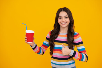 Child girl holding coffee cup. Coffee break and recess. Teenager hold plastic take away cup, drink cocoa, coffee or tea beverage. Happy teenager, positive and smiling emotions of teen girl.