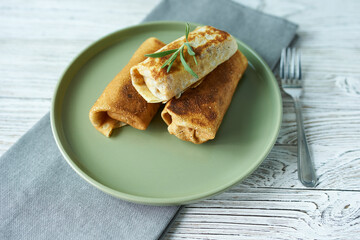 Pancakes and stuffing on a plate close-up. The concept is breakfast.