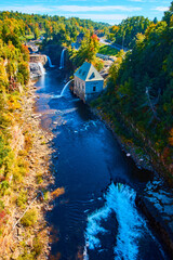 River valley with multiple large waterfalls and Hydroelectric power plant