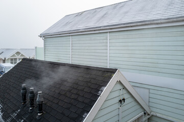 Trio of newly installed condenser boiler heating ducts seen at a large coastal hotel. Steam can be...