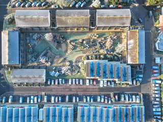 Drone view of a large holiday complex seen on a frosty morning during mid winter. The outdoor recreation area and large restaurant area can be seen.