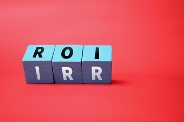colored cubes with letters ROI and IRR or Return On Investment and internal rate of return