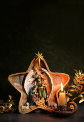 Traditional Christmas native scene and candle on dark abstract background. Star of Bethlehem,...