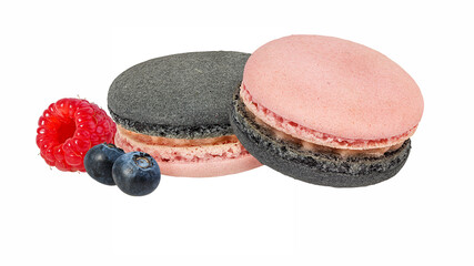 Tasty purple macarons with blueberry and raspberries isolated on white background.