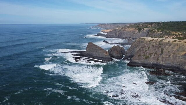 cliffs by drone, in odeceixe portugal, sun and blue sky