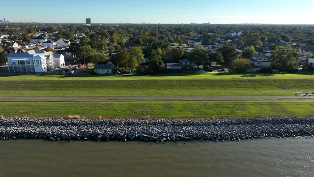 Floodwall to protect homes from flooding in Metairie Louisiana on banks of Lake Pontchartrain. Aerial truck shot.