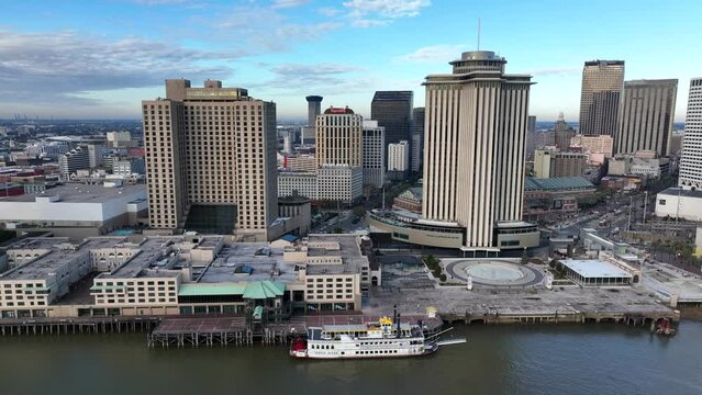 Mississippi River at New Orleans. Downtown skyscraper highrise buildings. Aerial truck shot with riverboat on water.