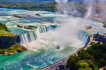 Detailed view of entire Niagara Falls Horseshoe Falls from above in Canada with tourist ship by...