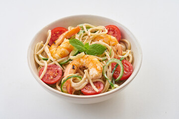 Spaghetti in a bowl, salad on white background             
