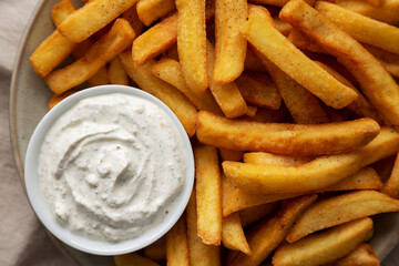 Homemade French Fries with Ranch Dressing on a Plate, top view. Flat lay, overhead, from above. Close-up.