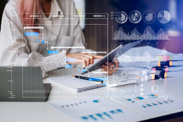 Businessman hand Project manager working and update tasks and Gantt chart scheduling virtual diagram.with smart phone, tablet and laptop in office..