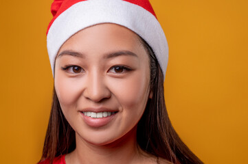 Portrait picture of a cute smiling young gilr in santa hat