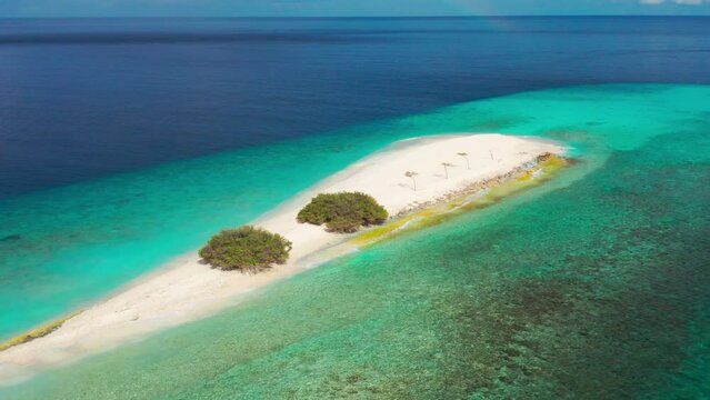 Aerial view of sandbar and blue sea. Maldivian sandbank in Indian ocean, white sandy coast crystal azure color water, perfect getaway for tropical vacations.