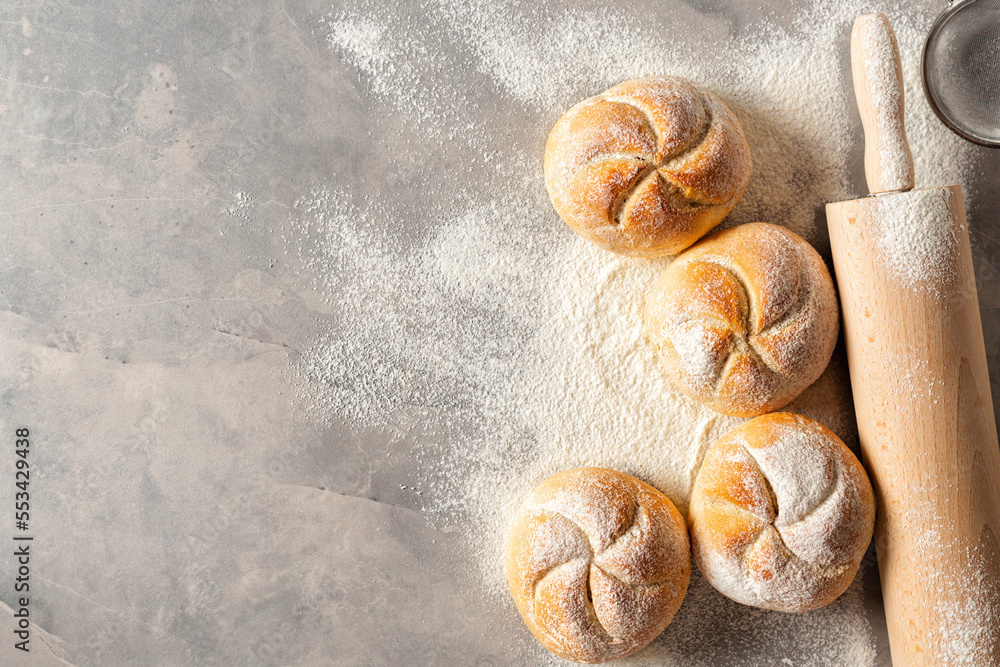 Aufkleber mini bun bread on a white background with rolling pin top view copy space. home baking concept