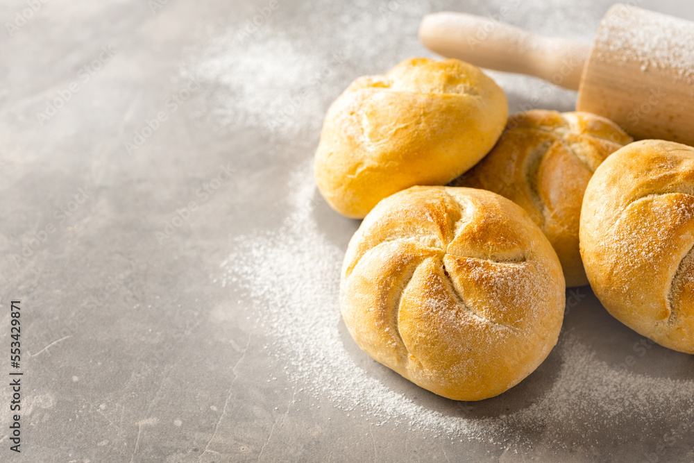 Poster mini bun bread on a white background with rolling pin copy space. home baking concept