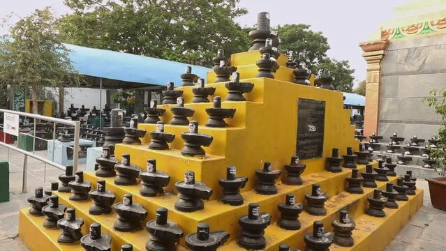 Shivalingas arranged in a triangular built stairs or steps at temple