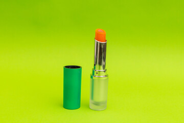 Green lipstick on green background, monochrome