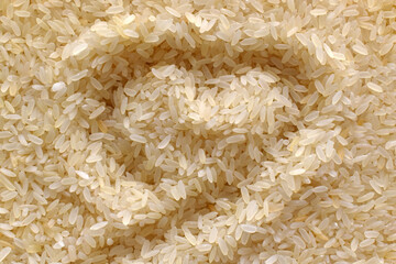 Uncooked rice with a heart shape background.  Parboiled rice background.