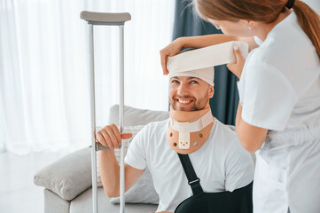 Woman is helping injured man at home