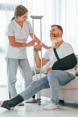 Nurse is helping injured man at home